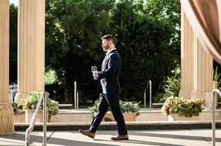 Team Member Walking with wine bottle in hand