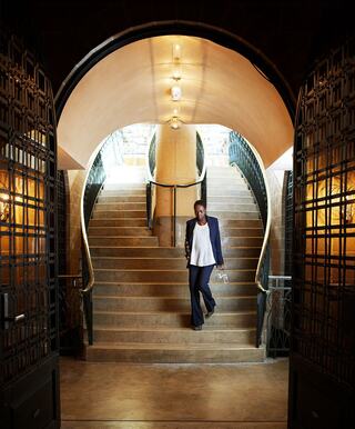 server walking down stairs to barrel chai