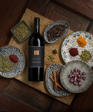 Bottle of Shiraz with dishes of exotic spices